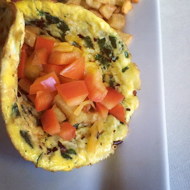 Egg burrito, spinach, onions, tomatoes, red bell peppers, crushed red peppers, homemade hashed potatoes, natural cheese